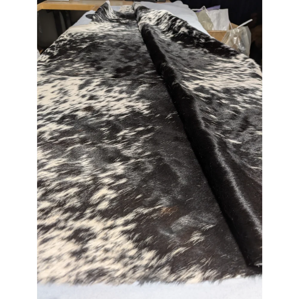Extra large cowhide rug with black white speckled pattern and leather texture