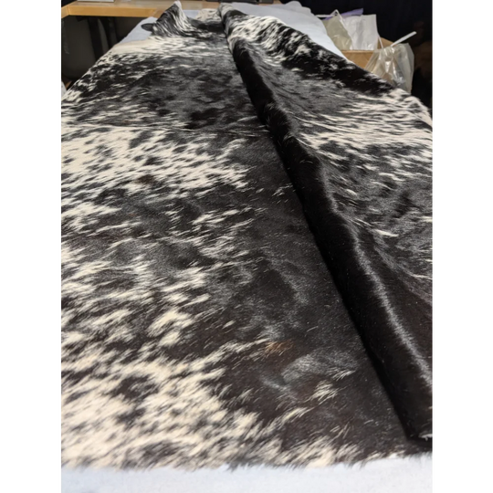 Extra large cowhide rug with black white speckled pattern and leather texture