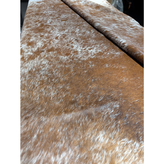 Extra large cowhide rug with brown and white faux fur throw blanket, unmistakable aura
