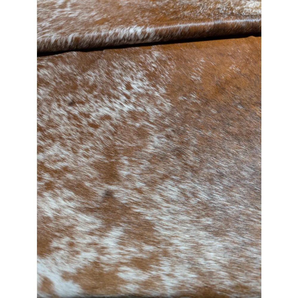 Extra large brown and white cowhide rug with natural texture and unmistakable aura