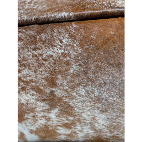 Extra large brown and white cowhide rug with natural texture and unmistakable aura