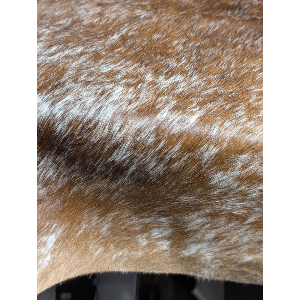 Extra large brown and white speckled cowhide rug with unmistakable aura