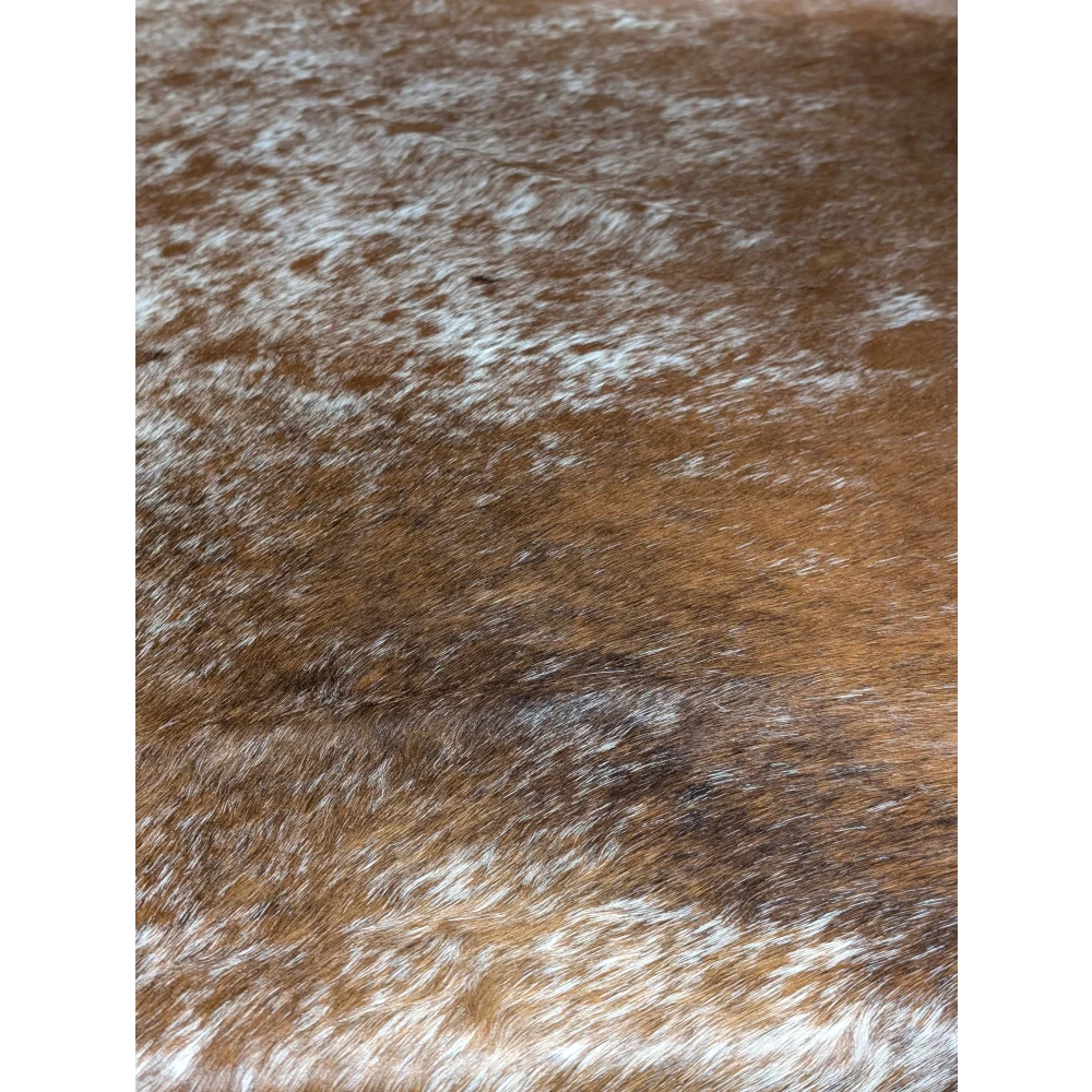 Extra large brown and white cowhide rug with natural texture and unmistakable aura