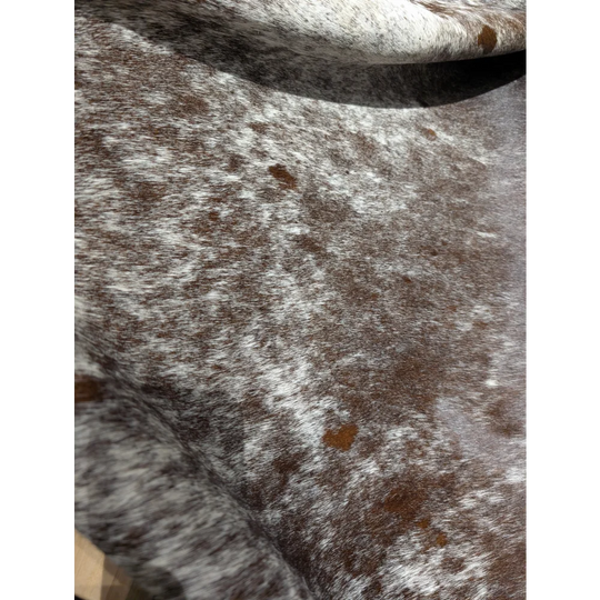 Extra large Angus Oliver cowhide rug with brown white speckled textured blanket