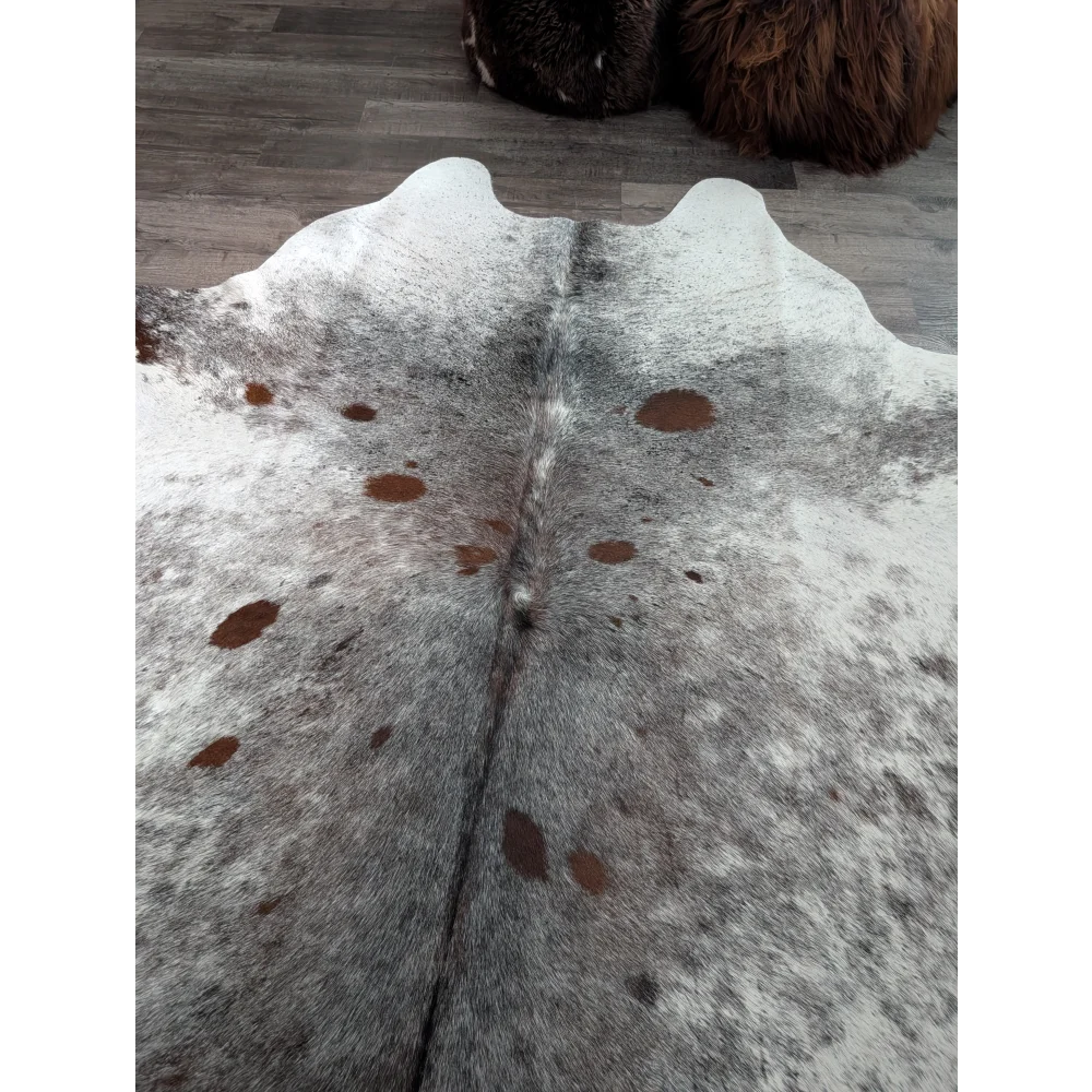 Saltpepbrn#141 extra large cowhide rug with natural gray white and brown spots featuring a soft textured surface