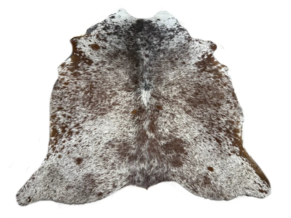A large cowhide rug saltpepbrn19 with a unique speckled pattern of white brown and black fur perfect for beautiful rugs
