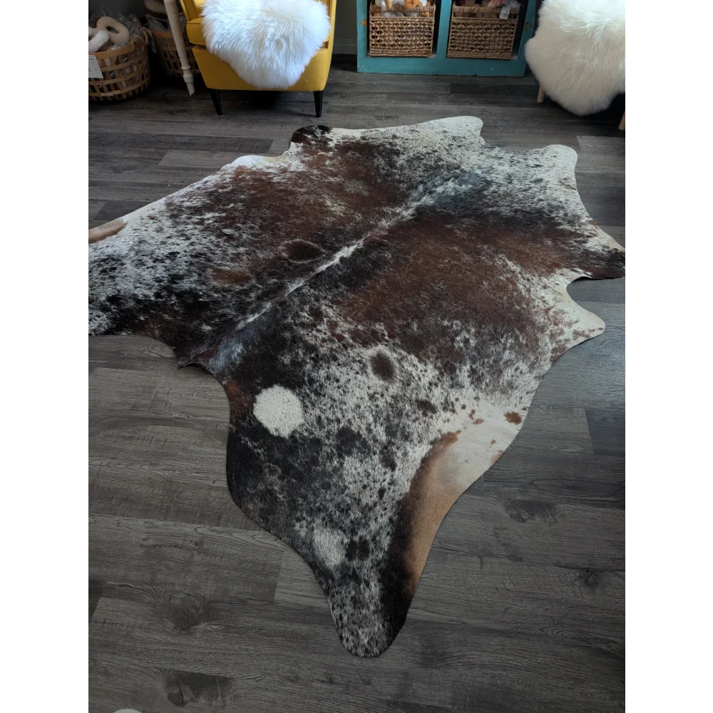 A beautiful extra large cowhide rug saltpepbrn193 with mottled brown black and white patches natural hide