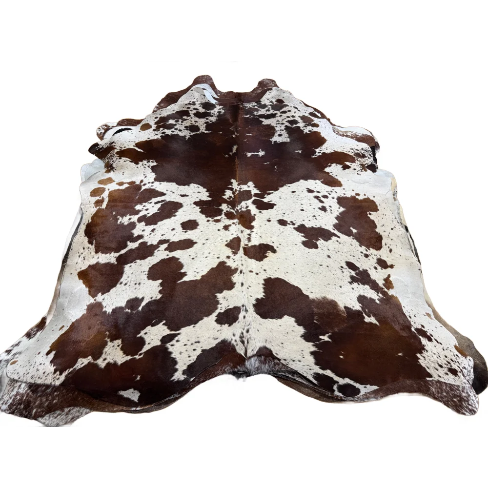 Beautiful extra large cowhide rug featuring natural brown and white irregular patches perfect for stylish spaces