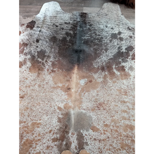 A beautiful extra large cowhide rug saltpepbrn203 with a mottled pattern of white brown and black patches