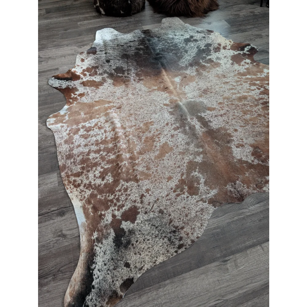 A beautiful extra large cowhide rug saltpepbrn 203 in natural tones with brown white and black mottled patches