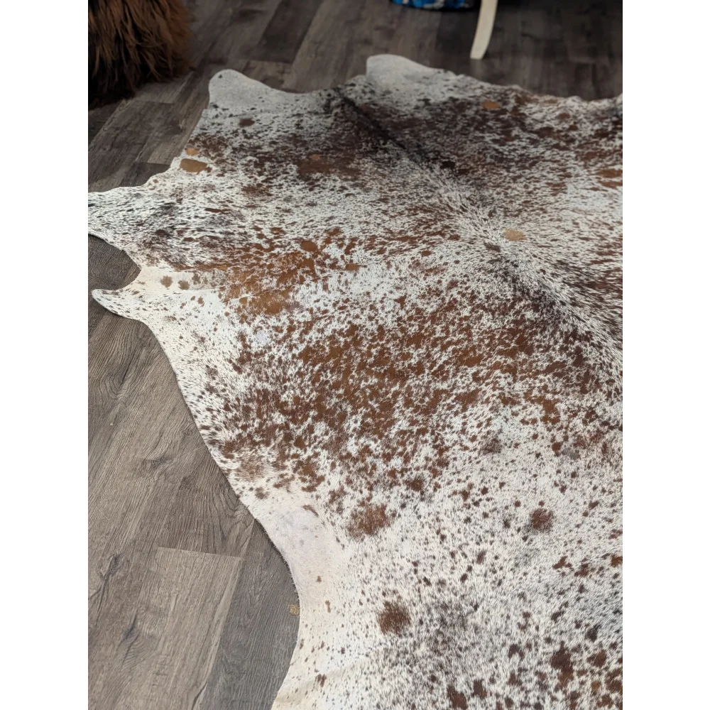 Extra large natural cowhide rug saltpepbrn31 with white base and brown speckles and irregular edges 98 by 86 inches