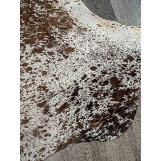 Brown and white spotted extra large cowhide rug saltpepbrn31 with natural fur texture measuring 98 by 86 inches