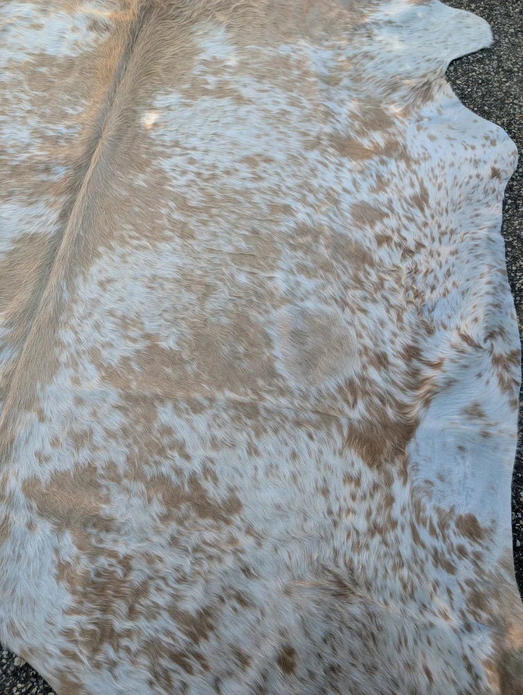 A large cowhide rug with rustic charm featuring white and tan mottled fur angus oliver saltpepbrn326 94 x 81