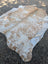 Large cowhide rug saltpepbrn#326 in tan and white with rustic charm by angus oliver measuring 94 by 81 inches