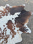 Brown and white large cowhide rug saltpepbrn358 with rustic charm and natural patches by angus oliver arriving soon