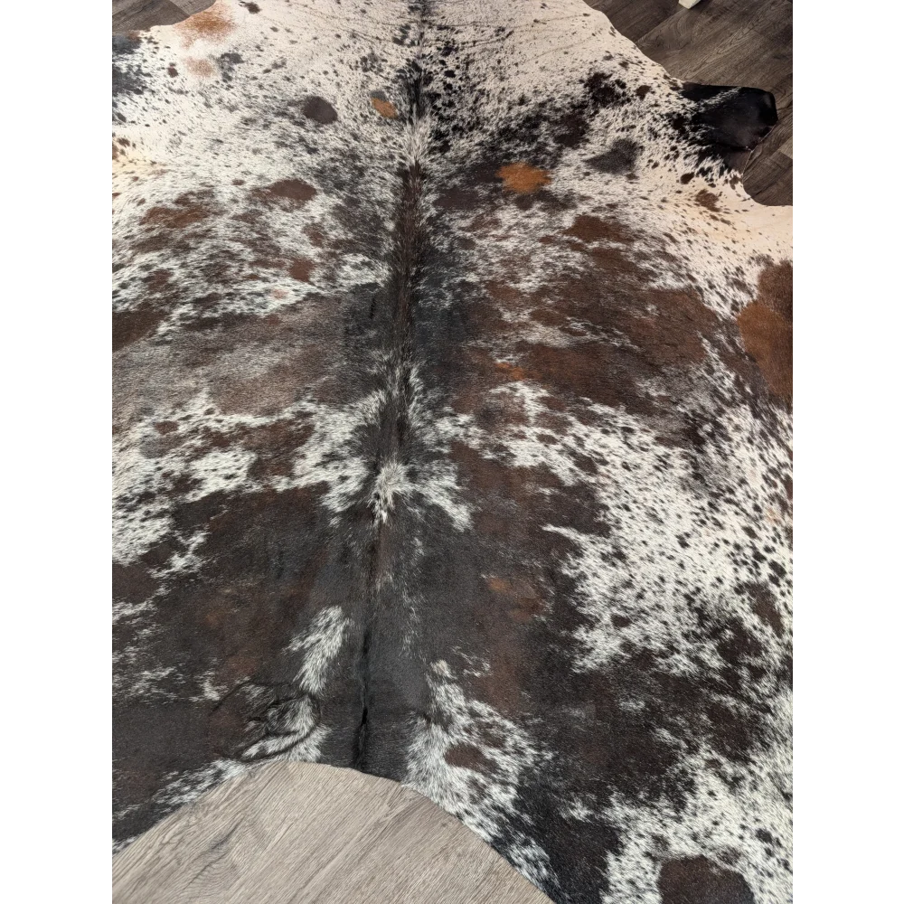 A natural extra large cowhide rug in black white and brown spotted pattern saltpepbrn38 96 by 83 inches