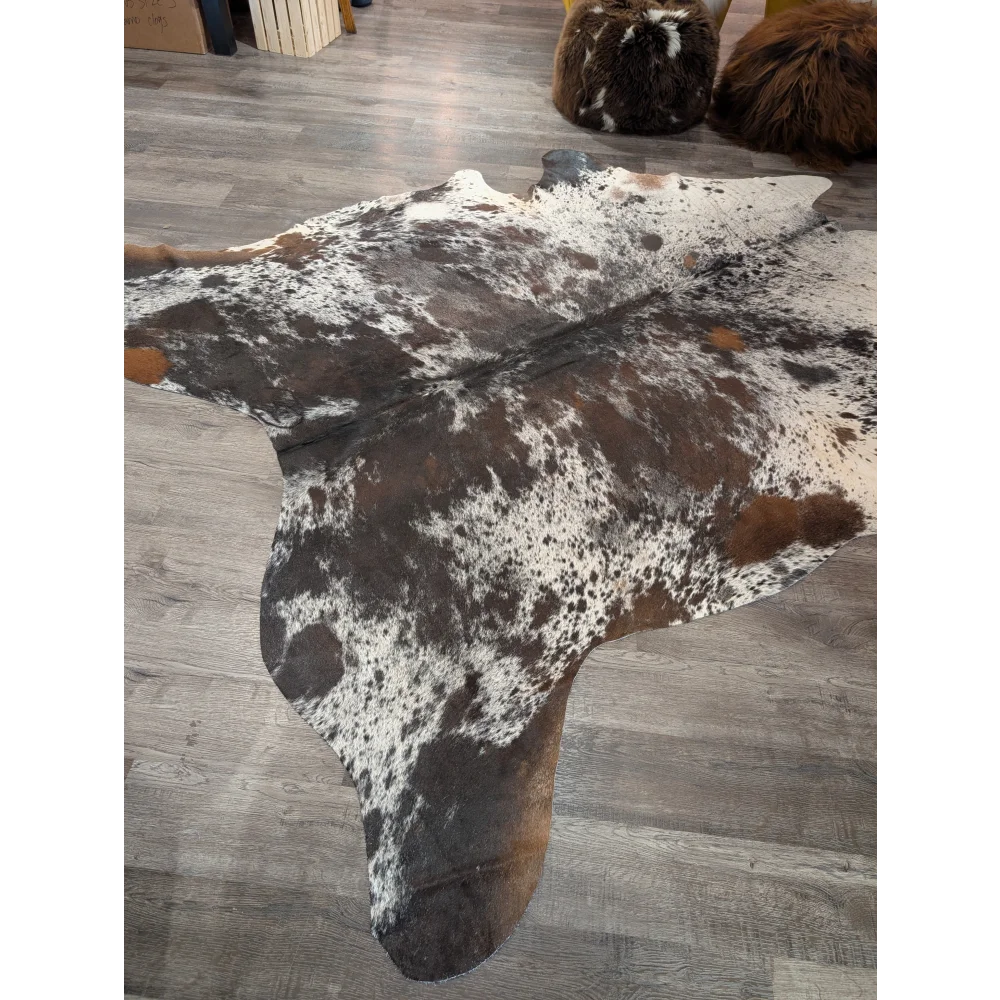 Brown and white spotted extra large cowhide rug with natural irregular patterns saltpepbrn 38 96 x 83 inches