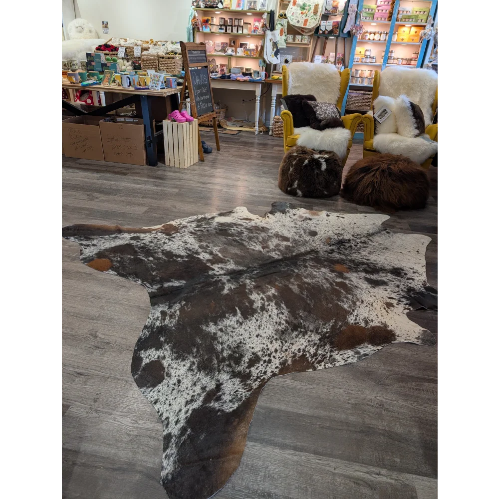 A natural extra large cowhide rug with a distinctive black white and brown spotted pattern saltpepbrn38