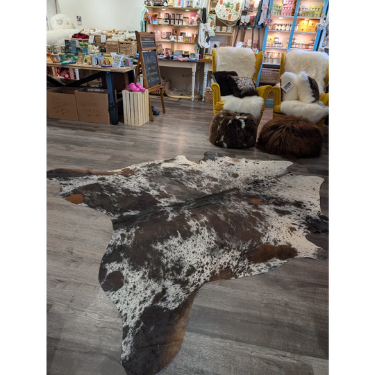A natural extra large cowhide rug with a distinctive black white and brown spotted pattern saltpepbrn38