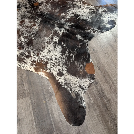 A large cowhide rug with black white and brown spots extra large natural saltpepbrn38 96 x 83 inches