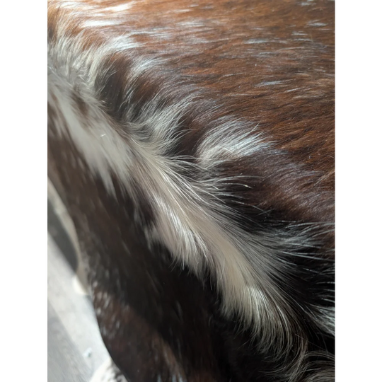 Gorgeous extra large cowhide rug with brown white fur and textured pattern