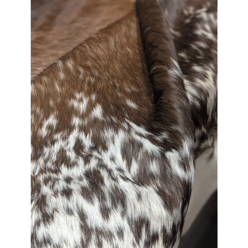 Extra large cowhide rug with brown and white speckled fur, textured pattern