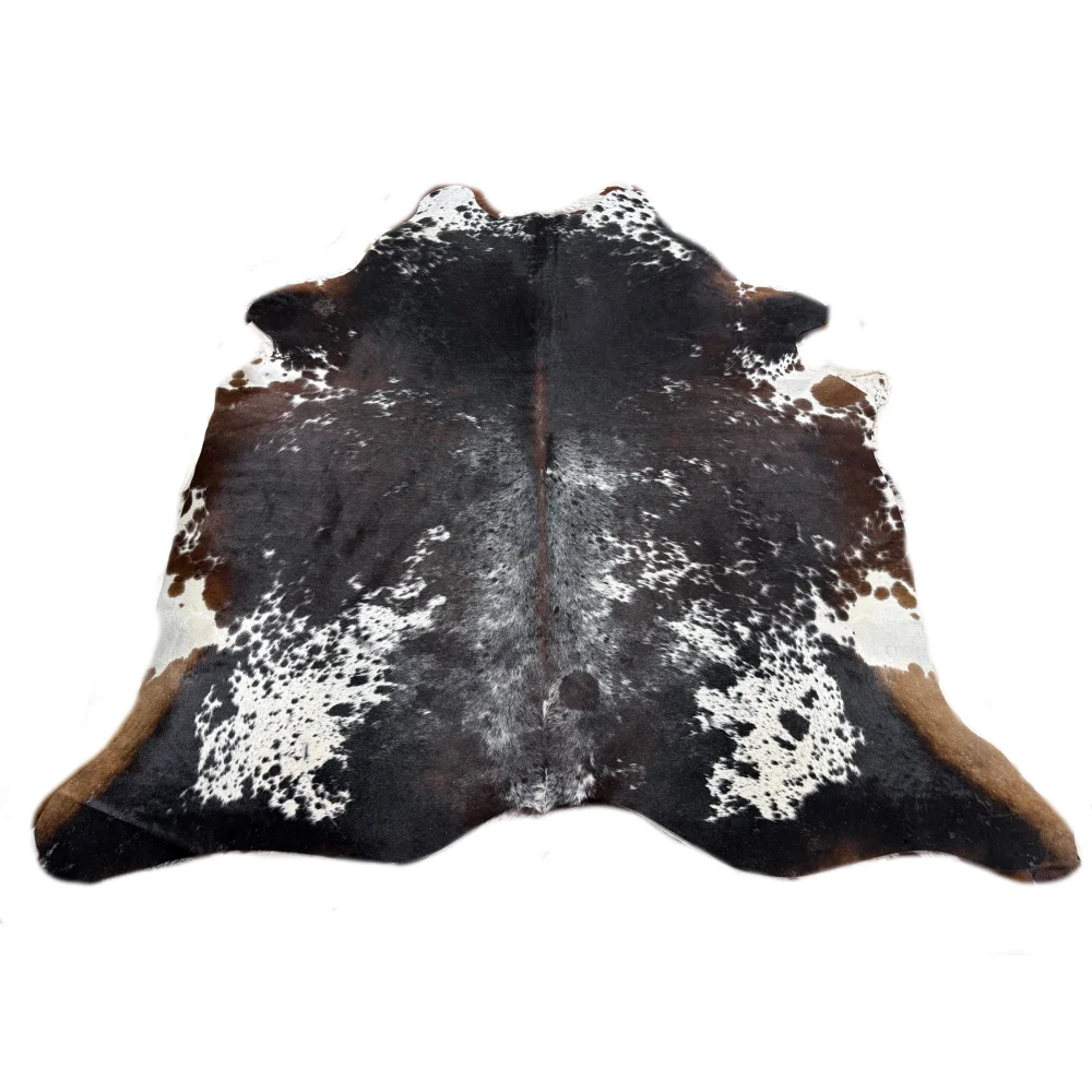 A natural extra large cowhide rug with rustic charm and unique black white and brown spotted pattern arriving soon
