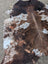 Large brown and white spotted cowhide rug saltpepbrown324 with natural fur texture and rustic charm