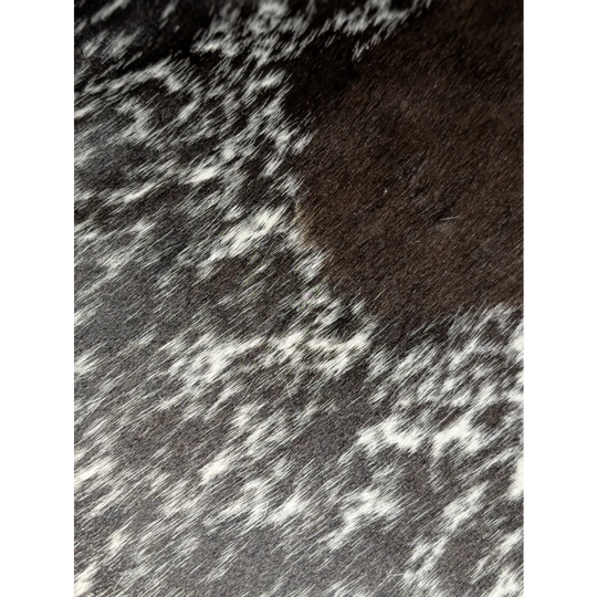 Close-up of black and white speckled extra large cowhide rug texture, soft underfoot