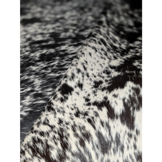Extra large cowhide rug with black and white spotted faux fur texture, soft underfoot