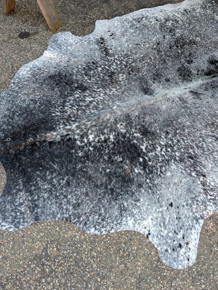 Large cowhide rug saltpeptricolour#478 with unique black and white speckled pattern adds rustic charm to any room