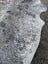 Large saltpep tricolour speckled gray and white cowhide rug with unique characteristics and rustic charm