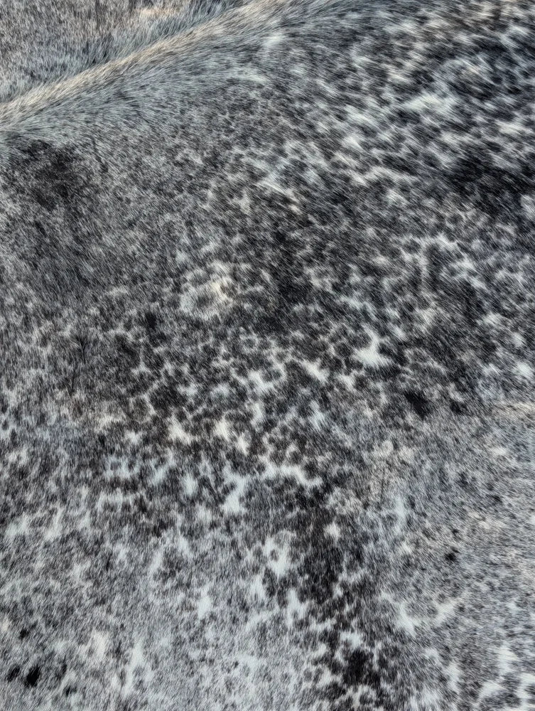 Large saltpep tricolour gray and white speckled cowhide rug with unique characteristics and rustic charm