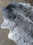 A large cowhide rug saltpeptricolour478 with unique black and white mottled pattern and rustic charm