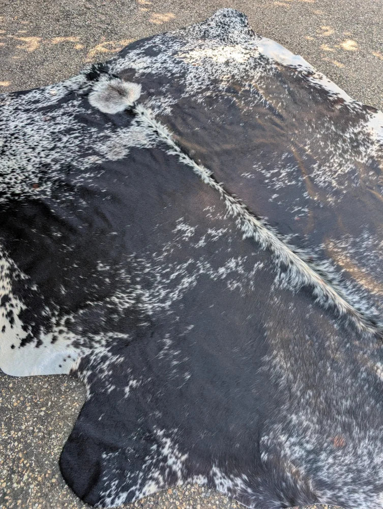 Saltpeptricolour large cowhide rug with black and white spots and natural textured surface offers rustic charm