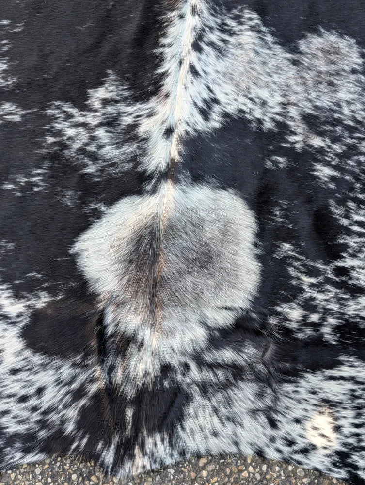 Large black and white cowhide rug saltpeptricolour#479 with fluffy natural fur texture and rustic charm
