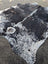 Large saltpeptricolour cowhide rug with black and white spots showcasing unique characteristics and rustic charm