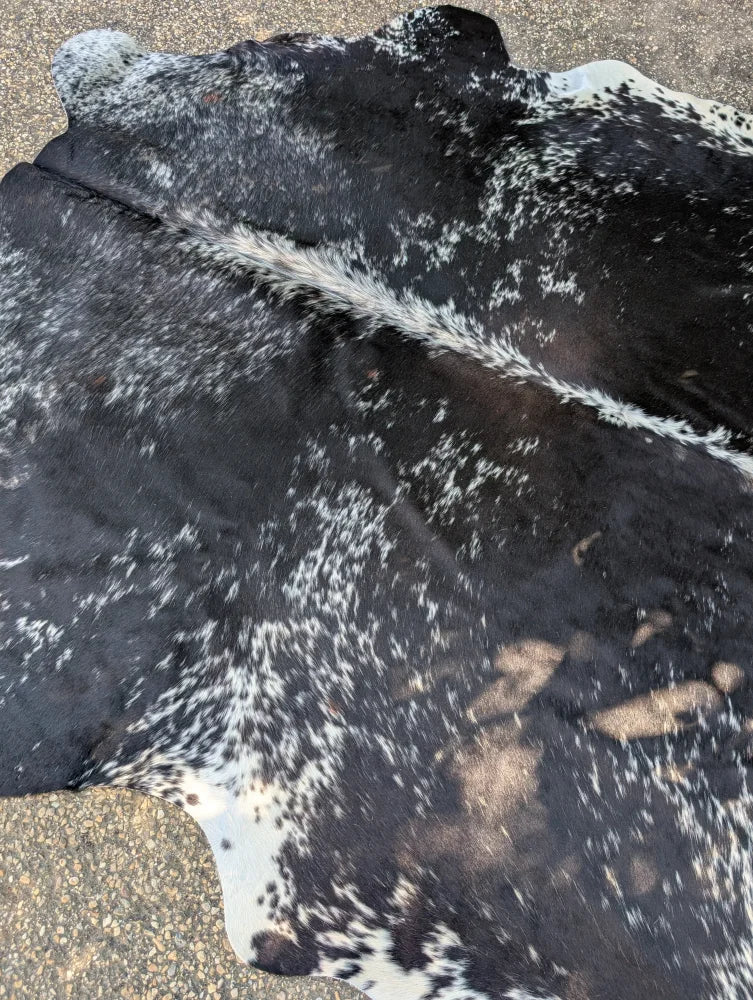 Large black and white spotted cowhide rug saltpeptricolour479 with natural fur texture and rustic charm unique characteristics