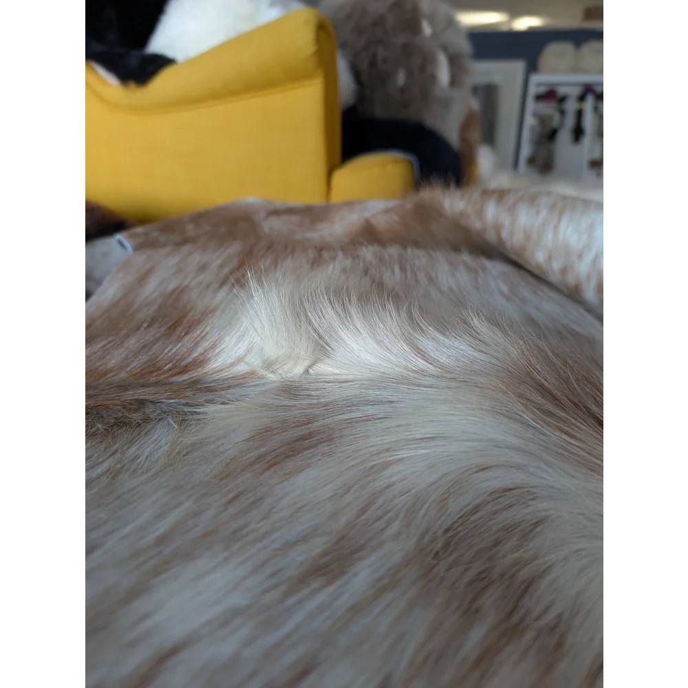 A large cowhide rug salty2 by angus oliver featuring a plush beige and white faux fur throw blanket texture
