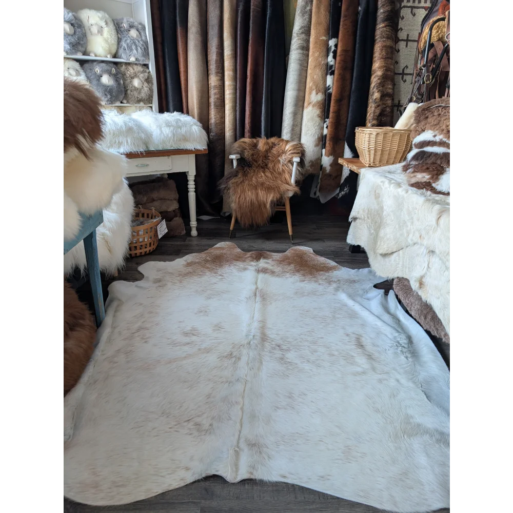 A large soft angus oliver cowhide rug in natural white and brown perfect for beautiful rugs collection