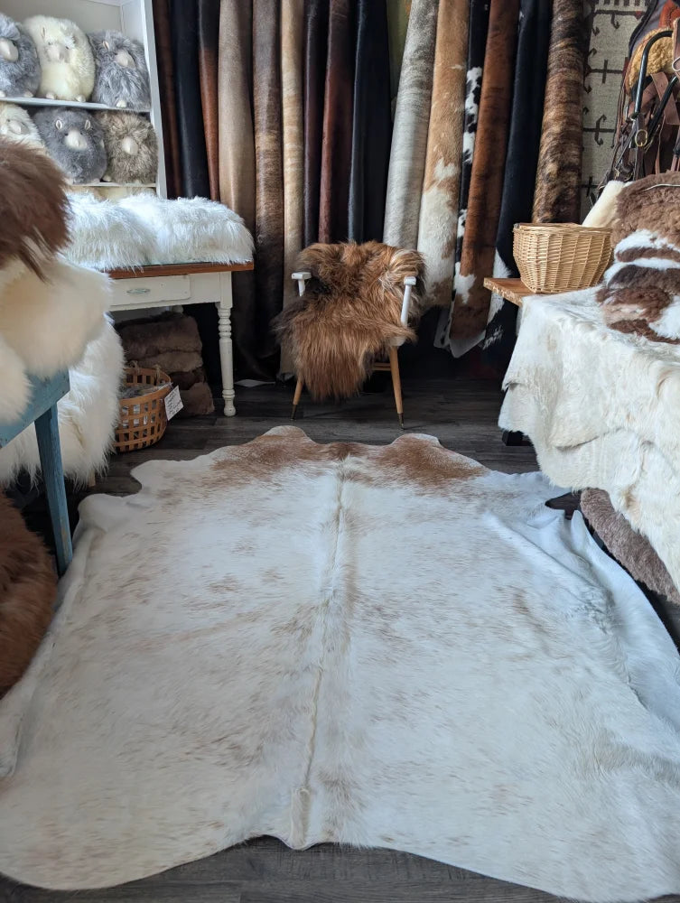 A large soft angus oliver cowhide rug in natural white and brown perfect for beautiful rugs collection