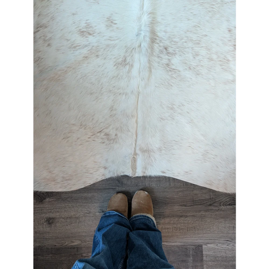 A large cowhide rug salty2 by angus oliver in soft white and beige with natural fur texture perfect for beautiful rugs