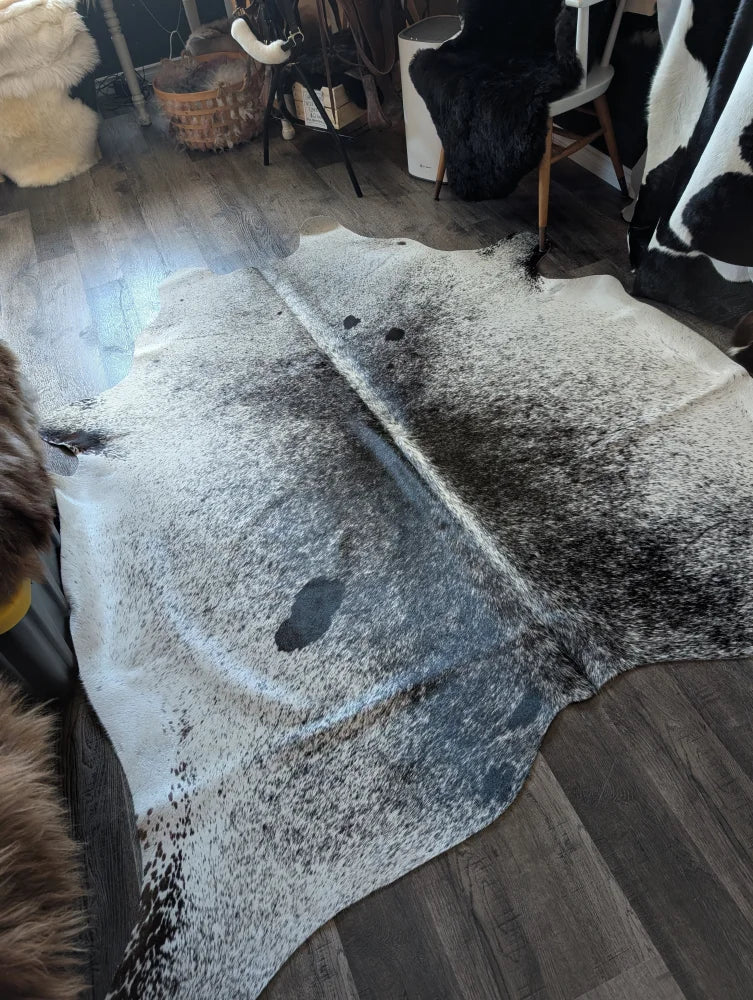 Extra large natural cowhide rug salty3 with white base and black speckles adds rustic charm to your space