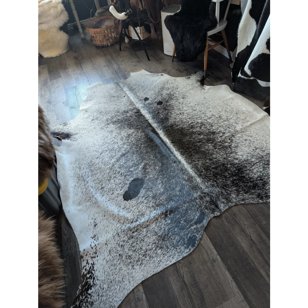 Extra large natural cowhide rug salty3 with white base and black speckles adds rustic charm to your space