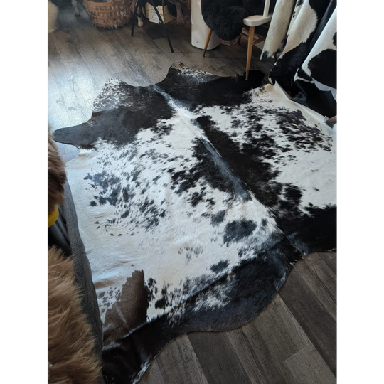 Black and white large cowhide rug with natural irregular patches for rustic charm in beautiful rugs collection
