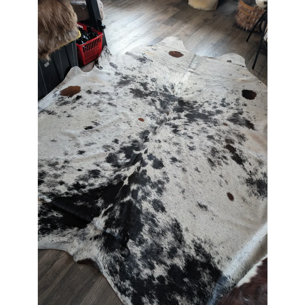 Large cowhide rug salty9 with natural white and black irregular patches adds rustic charm to beautiful rugs collection