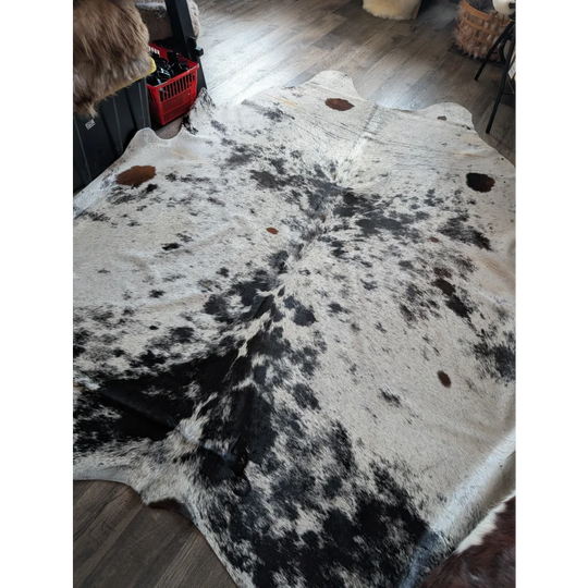 Large cowhide rug salty9 with natural white and black irregular patches adds rustic charm to beautiful rugs collection