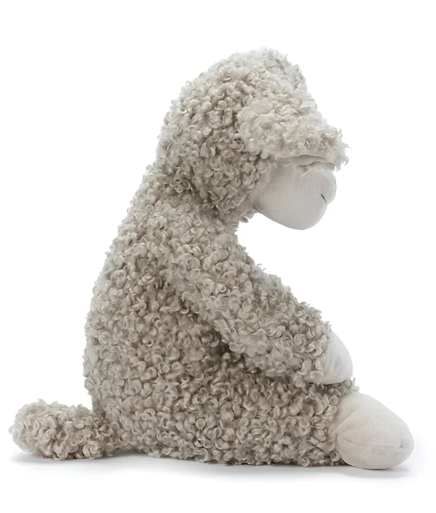 A soft cream-colored sheep plush toy named sammy the sheep with curly textured fur in a gentle seated pose