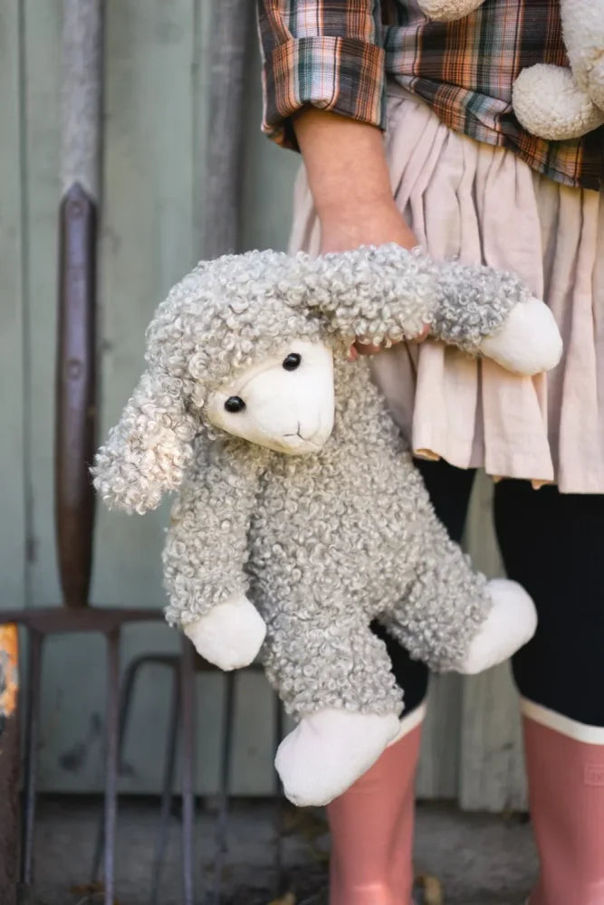Sammy the sheep is a soft gray stuffed toy with curly fur and white face and paws perfect for cuddling