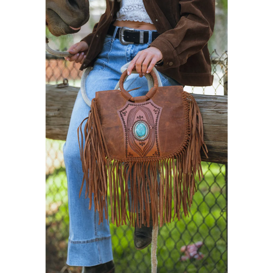 Sedona tassle bag in saddle brown with turquoise stone centerpiece